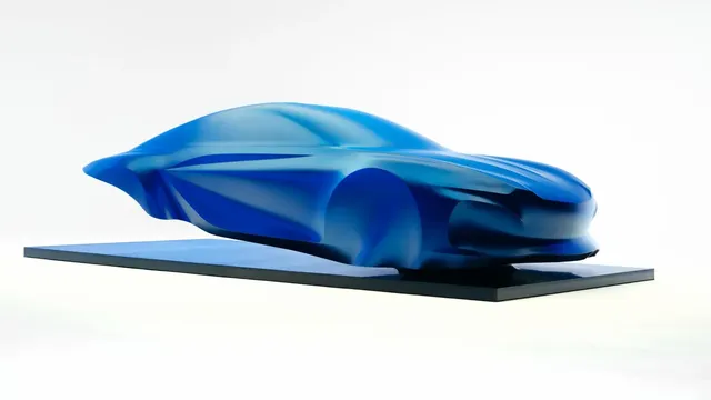 Sculpture de la future Alpine A110 électrique recouverte d'un voile bleu, présentée au Mondial de Paris 2026